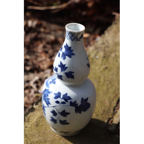 968 - A Chinese blue & white double gourd vase decorated with a bird amongst flowering foliage, four chara... 