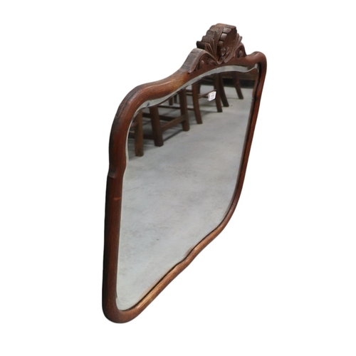 1125 - An oak framed wall mirror, overall 86 by 79cms.