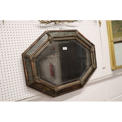 1064 - An 18th century cushion shaped mirror with ornate edge panels, overall 54 by 71cms.