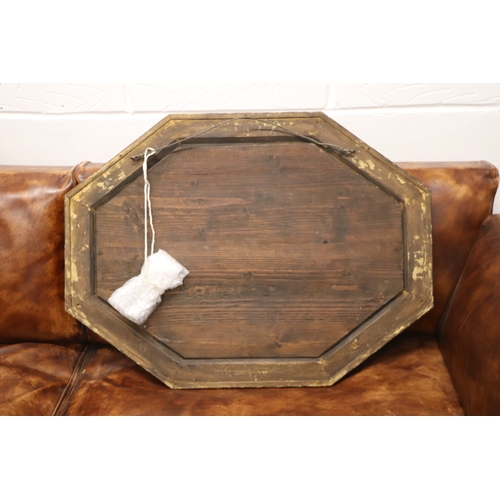 1064 - An 18th century cushion shaped mirror with ornate edge panels, overall 54 by 71cms.