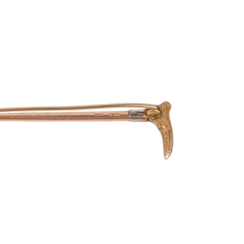 Hunting interest. A 9ct gold riding crop bar brooch with 18ct white ...