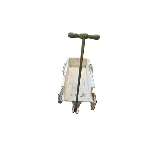 27 - A distressed painted pull-along cart with iron bound spoked wheels, 93cms long without handle.