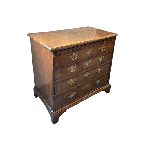 914 - An 18th century walnut chest with brushing slide above four graduated long drawers, on bracket feet,... 