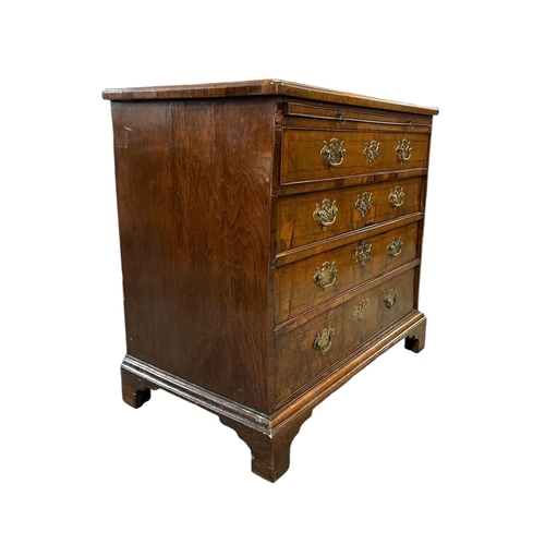914 - An 18th century walnut chest with brushing slide above four graduated long drawers, on bracket feet,... 