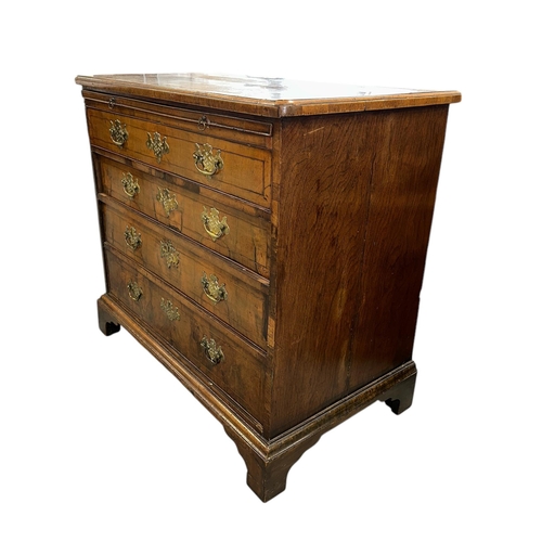 914 - An 18th century walnut chest with brushing slide above four graduated long drawers, on bracket feet,... 