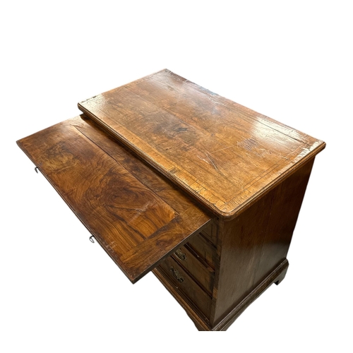 914 - An 18th century walnut chest with brushing slide above four graduated long drawers, on bracket feet,... 