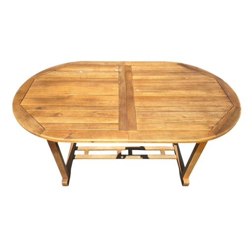 6 - A teak extending garden table, 90 by 150cms unextended.
