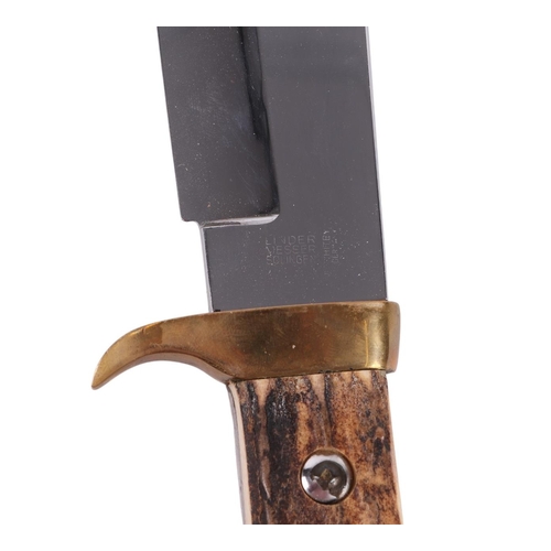 101 - A mid 20th century Bowie knife with brass mounted antler handle in a tooled leather scabbard, the bl... 