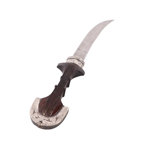 106 - A late 19th / early 20th century North African Koummya dagger with white metal mounted hardwood hand... 