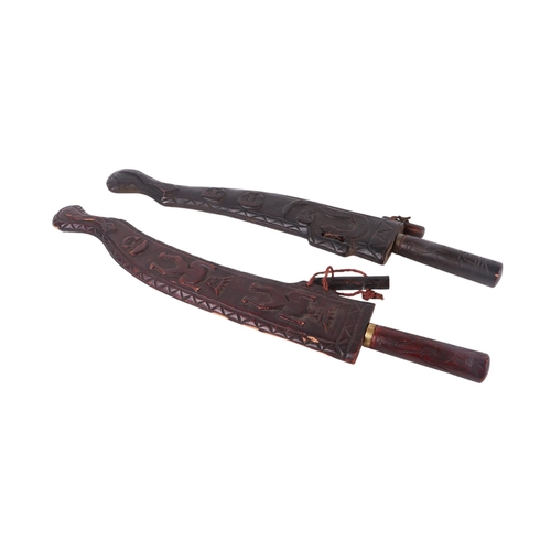 107 - Two early / mid 20th century Taiwan aboriginal swords with carved hardwood scabbards, each approx 61... 