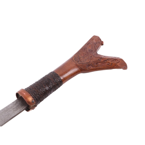 110 - A 20th century Sarawak / Malay small Mandau sword with carved hardwood and woven rattan handle, the ... 