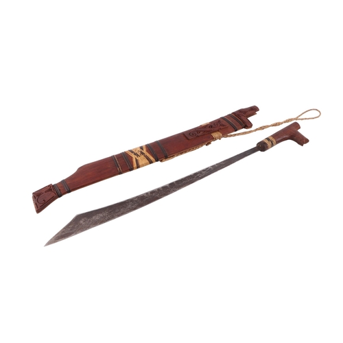 60 - A mid 20th century small Borneo Kayan Mandau Dayak sword and scabbard, overall 64cms, blade length 4... 