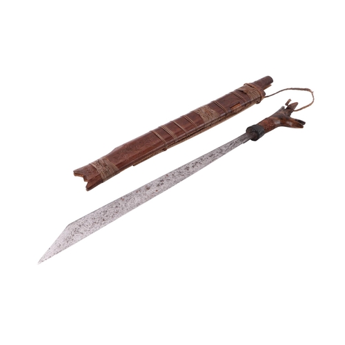 61 - A mid 20th century Borneo Dayak heavy Mandau sword, having a carved hardwood and copper wirework gri... 