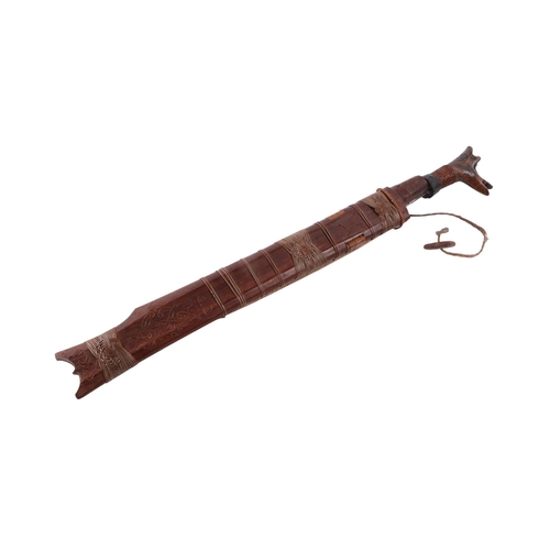 61 - A mid 20th century Borneo Dayak heavy Mandau sword, having a carved hardwood and copper wirework gri... 