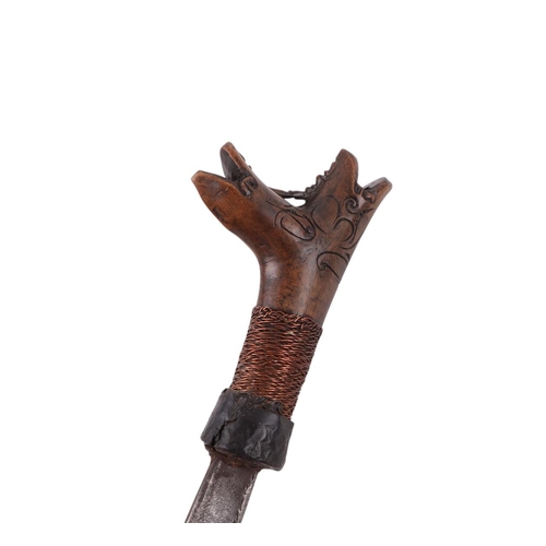61 - A mid 20th century Borneo Dayak heavy Mandau sword, having a carved hardwood and copper wirework gri... 