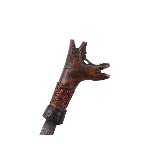 61 - A mid 20th century Borneo Dayak heavy Mandau sword, having a carved hardwood and copper wirework gri... 