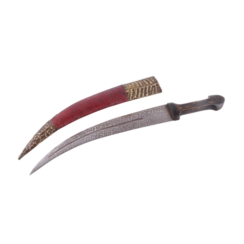 66 - An early 20th century Sudanese Islamic jambiya knife with wooden handle and brass mounted leather sc... 