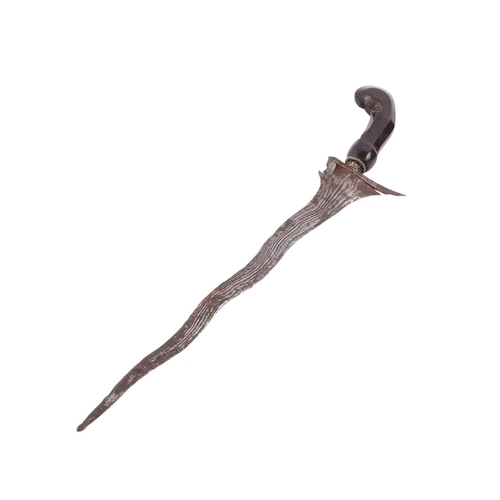 72 - A 19th century Javanese Kris / Keris Yogyakarta knife with carved hardwood handle and wavy steel bla... 