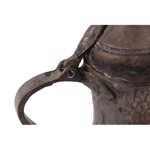 733 - A Turkish / Islamic brass dallah coffee pot, 35cms high; together with a tinned copper Islamic / Tur... 