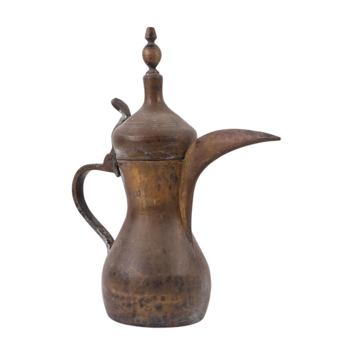 733 - A Turkish / Islamic brass dallah coffee pot, 35cms high; together with a tinned copper Islamic / Tur... 