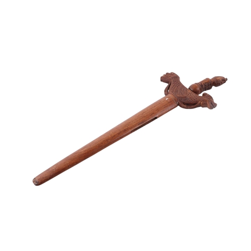 74 - A Javanese Madura Kris / Keris with figural carved hardwood handle and hardwood scabbard with stylis... 