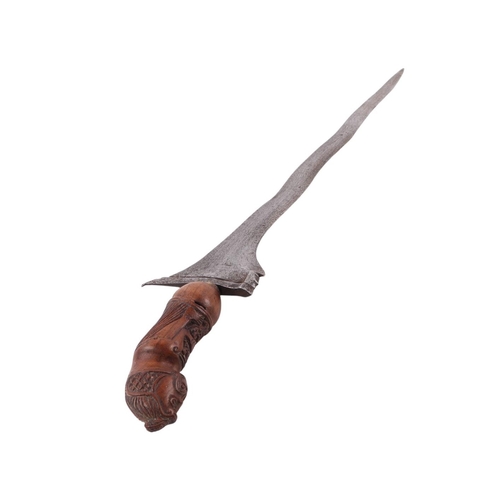 74 - A Javanese Madura Kris / Keris with figural carved hardwood handle and hardwood scabbard with stylis... 