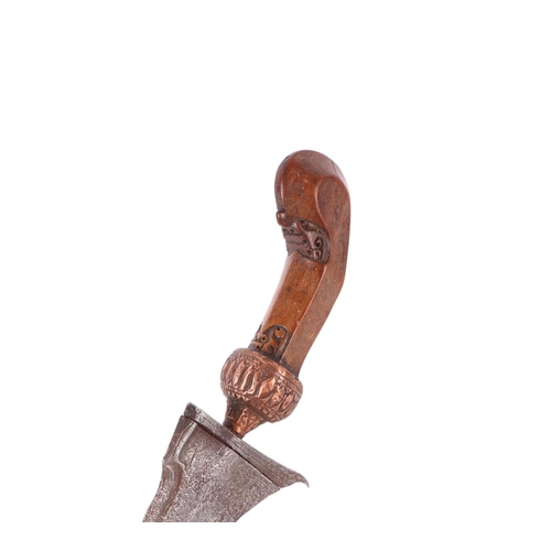 75 - A Javanese Kris / Keris with carved hardwood handle and copper Mendak and having a wavy steel pamor ... 