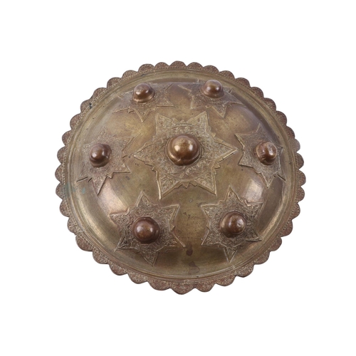 91 - A Sumatran Acehnese Peurise Teumaga brass shield, 26cms diameter.