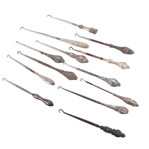 A collection of Victorian and later silver handled button hooks ...