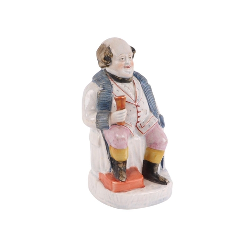 A 19th century Pearlware figure depicting a portly gentleman seated ...
