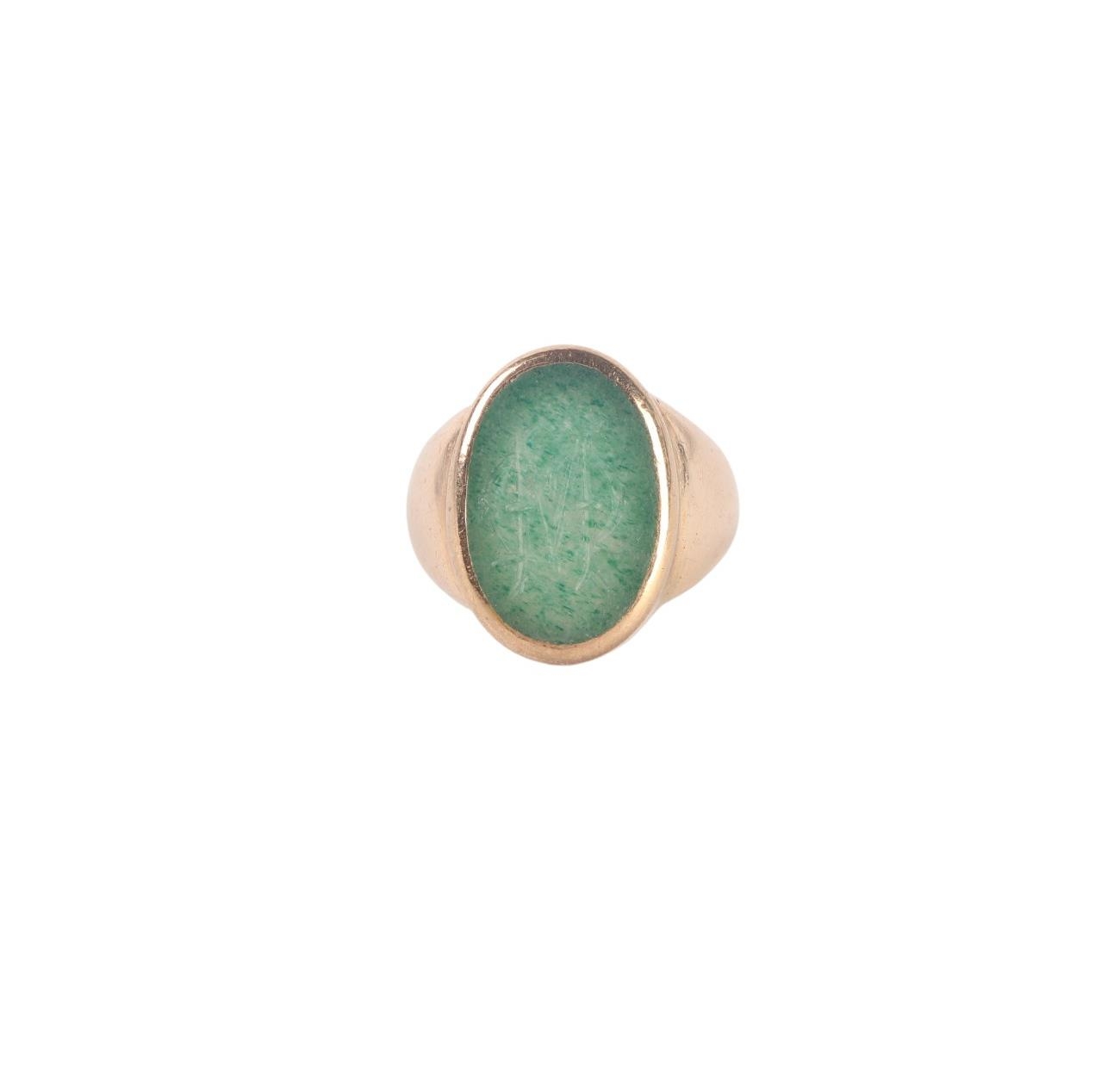 A gentleman's yellow metal signet ring set with an oval green stone ...