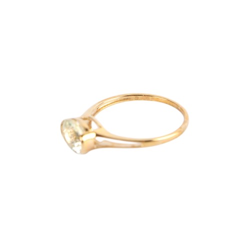 A 9ct gold solitaire dress ring, set with a single oval pale yellow ...