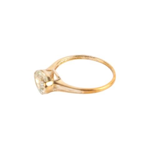 A 9ct gold solitaire dress ring, set with a single oval pale yellow ...
