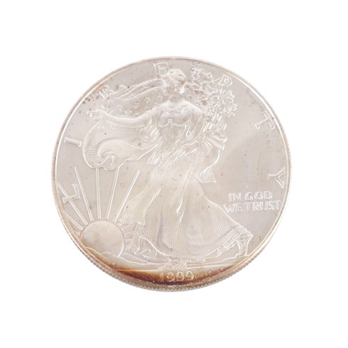 512 - A 1999 fine silver dollar coin.
