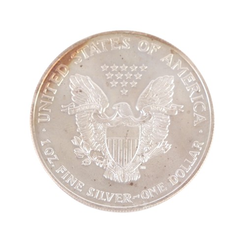 512 - A 1999 fine silver dollar coin.