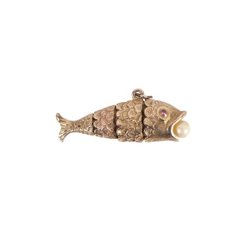 628 - A 9ct gold articulated fish pendant with ruby set eyes and a pearl in its mouth, 3.8cms long, 9.2g.