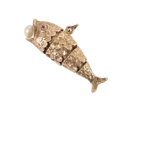 628 - A 9ct gold articulated fish pendant with ruby set eyes and a pearl in its mouth, 3.8cms long, 9.2g.