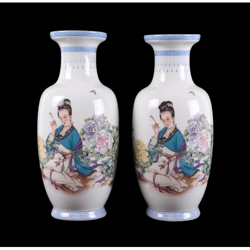 708 - A pair of Chinese Republic style vases decorated with a robed woman amongst flowers and calligraphy,... 