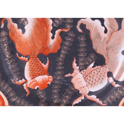 724 - A pair of large Japanese Meiji period Kutani plates decorated with goldfish on a black ground, 30cms... 