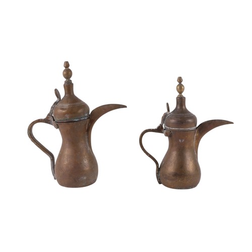 749 - A brass Turkish / Islamic dallah / coffee pot, 25cm high, and another similar 22cm high (2).