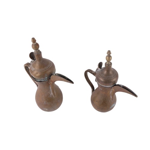 749 - A brass Turkish / Islamic dallah / coffee pot, 25cm high, and another similar 22cm high (2).