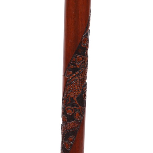 758 - A Chinese carved wooden standard lamp, 155cms high.