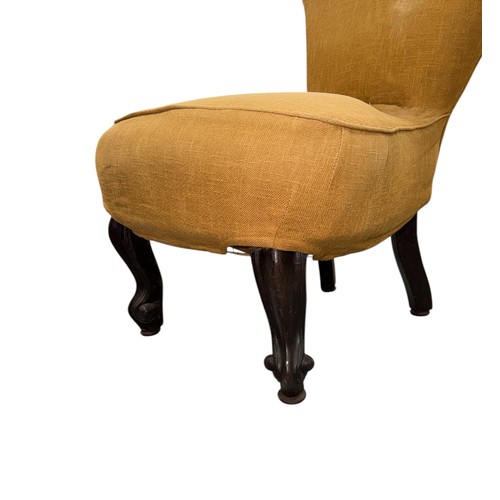 786 - A Victorian upholstered nursing chair with spoon back and seat and carved mahogany dwarf cabriole fr... 