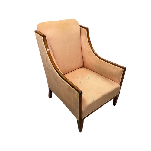 820 - A late 19th century silk upholstered armchair on square tapering front supports.