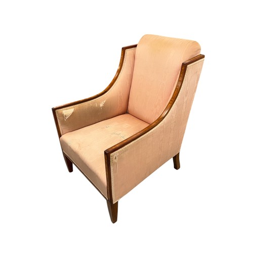 820 - A late 19th century silk upholstered armchair on square tapering front supports.