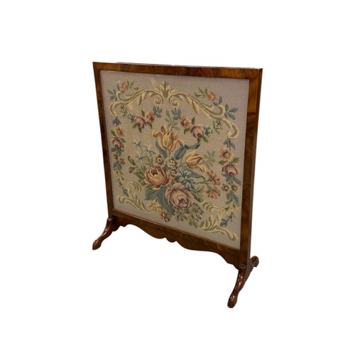840 - An early 20th century mahogany fire screen with woolwork panel, 58cms wide.