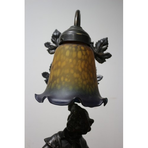 21 - Very Nice Lamp Depicting a Boy with Leaves Behind Him and a Mottled Glass Shade