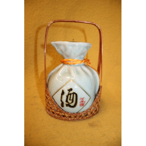 144 - Sake / Saki Decanter with Contents in Wicker Basket