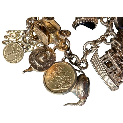 24 - 9ct Gold Charm Bracelet with Several 9ct Charms plus Sovereign and French Coin - Total Weight 110.6g... 