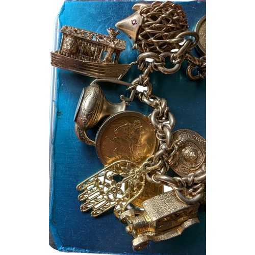 24 - 9ct Gold Charm Bracelet with Several 9ct Charms plus Sovereign and French Coin - Total Weight 110.6g... 